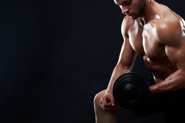 muscular-young-man-lifting-weights
